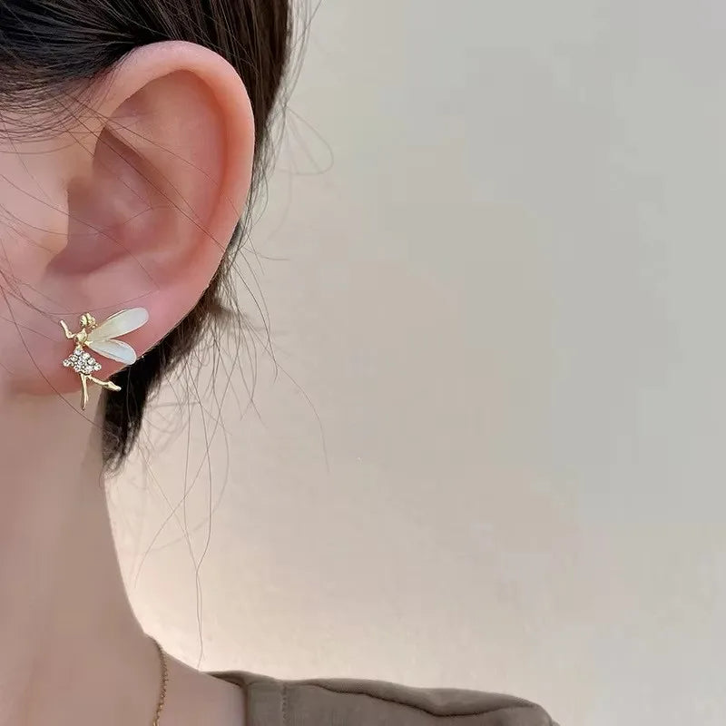 Boucle d'Oreille Enfant Petite Fée Délicate, porté par une mannequin, on ne voit que son oreille et son coup, elle a les cheveux attachés. Image