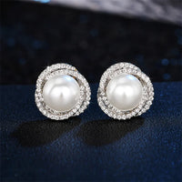 Boucle d'Oreille Femme Perle Design Croisé sur fond bleu