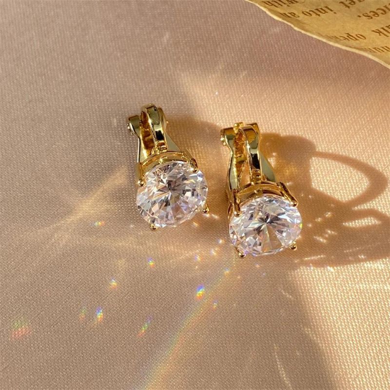 Boucles D'oreilles Clips Dorée Pierre Blanche Image